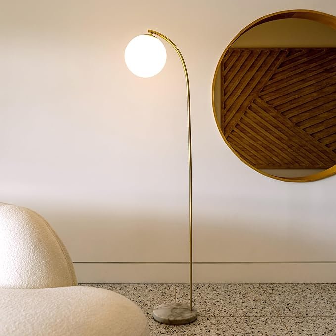 Brightech Luna Drop LED Floor Lamp, arcing mid-century modern standing lamp with frosted glass globe and brass finish, perfect for stylish interiors.