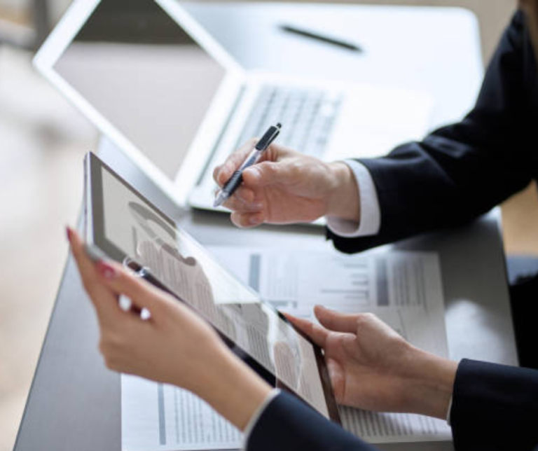 Executive in business attire working at clean minimalist desk in modern office