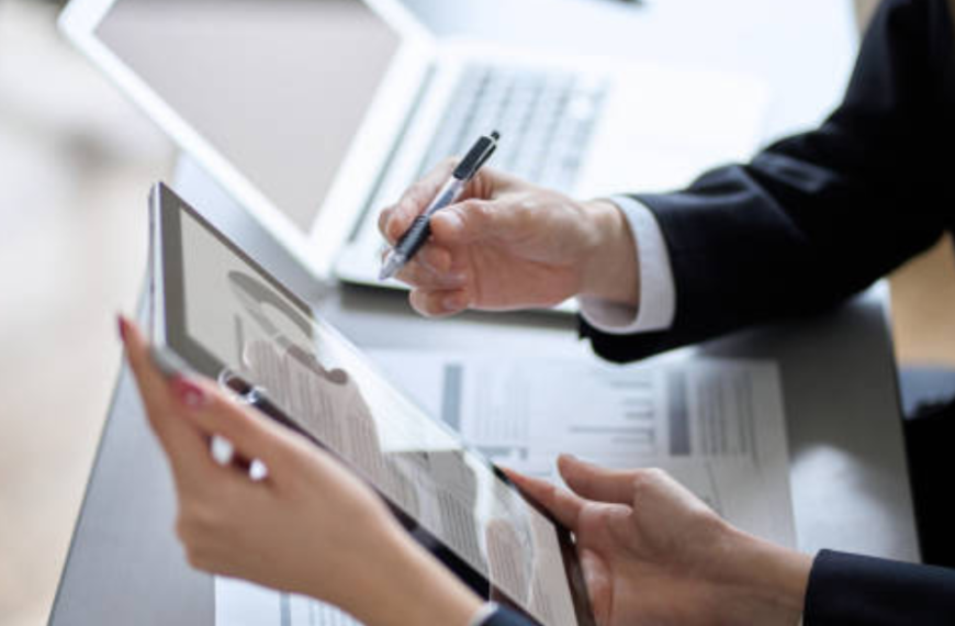 Executive in business attire working at clean minimalist desk in modern office