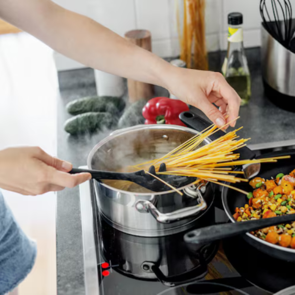 person cooking dinner with kitchen gadgets on counter