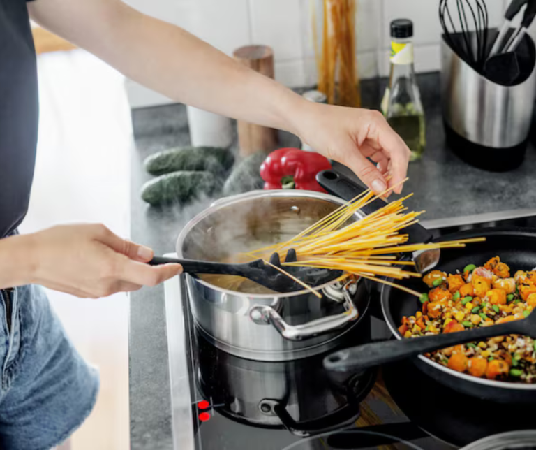 person cooking dinner with kitchen gadgets on counter